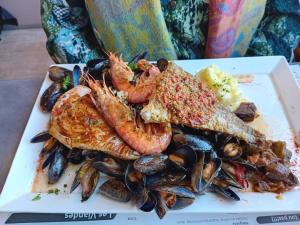 a plate of food with shrimp and toast and mussels at CAMPA'Gite in Toiras
