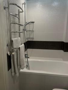 ein Badezimmer mit Badewanne und Dusche inklusive Handtüchern in der Unterkunft Spacious apartment with a beautiful view in Căuşeni + 10 Fotos
