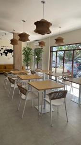 a group of tables and chairs in a restaurant at Urban Hostel Mindelo in Mindelo