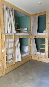 two wooden bunk beds in a room at Urban Hostel Mindelo in Mindelo