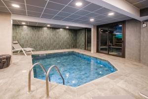 a large swimming pool in a room with at Hotel Emeraude in Peisey-Nancroix