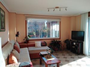 a living room with a couch and a tv at Paradise in Vigo in Vigo +2 photos