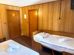 En eller flere senge i et værelse på Locanda del Lysjoch