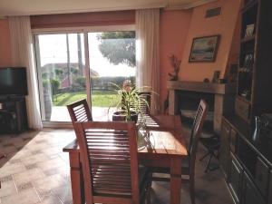 a dining room with a table and chairs and a fireplace at Paradise in Vigo in Vigo