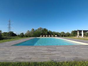 a large swimming pool with a blue at Glamping Podere Poggiagrilli in San Gervasio