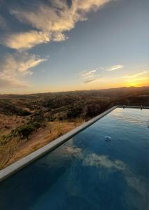 a swimming pool with a ball in the water at Natur Amêndoa in Odeleite