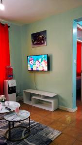 a living room with a flat screen tv on a wall at Makasembo breeze homes in Kisumu