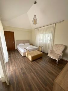 a bedroom with a large bed and a chair at Villa Prestige avec piscine in Tamaris +27 photos