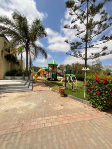a park with a playground with a slide at Villa Prestige avec piscine in Tamaris