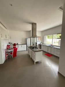 a large white kitchen with a table and a stove at Villa Prestige avec piscine in Tamaris