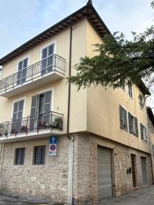 a building with two balconies on the side of it at Oltre le mura in Montefalco