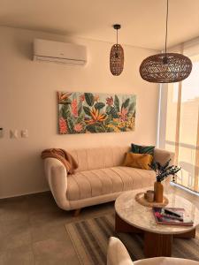 a living room with a couch and a table at Salguero Suites - Playa Salguero - By INMOBILIARIA VS in Santa Marta