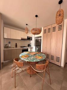 a kitchen with a table and chairs in a room at Salguero Suites - Playa Salguero - By INMOBILIARIA VS in Santa Marta +45 photos