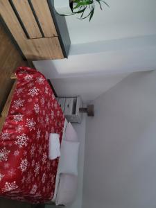 a red blanket on a toilet in a room at Ostre Natura in Ostre