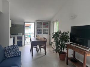 a living room with a table and a dining room at The Palm House in Santa Margherita Ligure