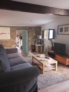 a living room with a couch and a coffee table at Casa da Figueira in Guilhufe