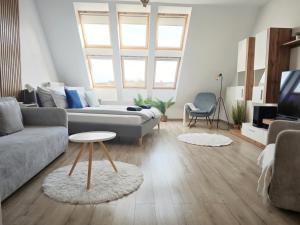a living room with a couch and a table at GreenStreetApartment in Kecskemét
