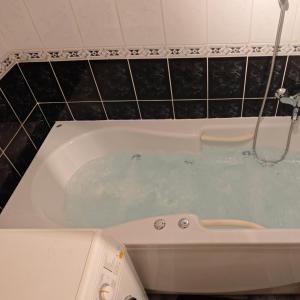 a bath tub filled with water in a bathroom at Apartment Bistrik mahala in Sarajevo