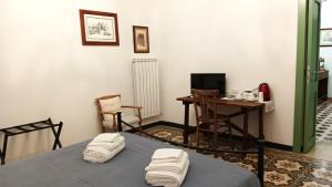 a room with a bed and a desk with a computer at La Casa Vecchia in Nuraminis +31 photos