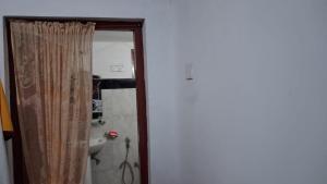 a bathroom with a shower curtain and a sink at WIJAYA Rest in Gampaha