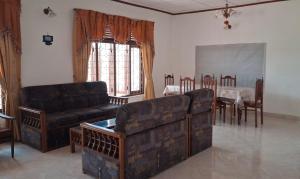 a living room with a couch and a table and chairs at WIJAYA Rest in Gampaha