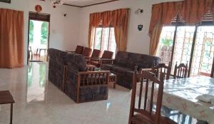 a living room with couches and a table and windows at WIJAYA Rest in Gampaha +47 photos
