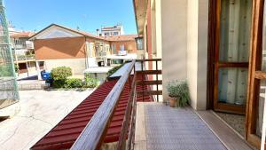 a balcony with a red bench next to a door at SE081 - Comodo trilocale a Marotta in Marotta