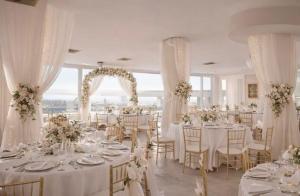 a wedding reception with white tables and chairs at Greif Hotel & Spa in Trieste +166 photos