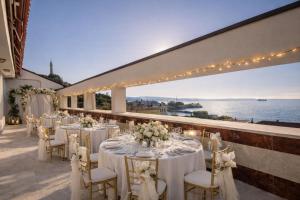 a wedding reception on the terrace of a hotel with tables and chairs at Greif Hotel & Spa in Trieste
