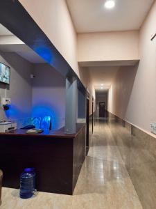 a hallway in a building with a blue wall at Laxmi Dham Guest House in Chhatikara