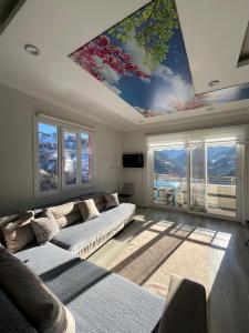a living room with a large painting on the ceiling at Dereli Suit Delux Ayder in Rize