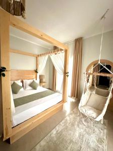 a bedroom with a swinging bed and a chair at Babushka Boutique Hotel-Dahab in Dahab +88 photos