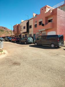 a parking lot with cars parked in front of a building at Maison d'hôte Najah 1 in Khenifra +11 photos