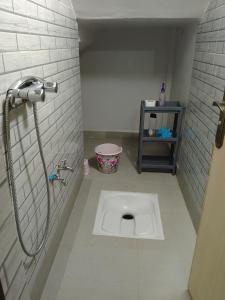 a bathroom with a shower and a toilet in the floor at Maison d'hôte Najah 1 in Khenifra