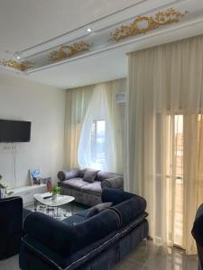 a living room with a couch and a table at Maison Jaspe in Brazzaville