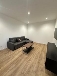 a living room with a couch and a table at Maison de ville a Berck in Berck-sur-Mer