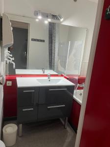 a bathroom with a sink and a mirror at Ancolie in Villarembert