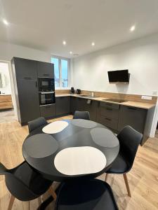a kitchen with a table and chairs in a room at Maison de ville a Berck in Berck-sur-Mer
