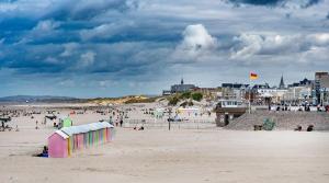 a beach with a bunch of people on the sand at Maison de ville a Berck in Berck-sur-Mer