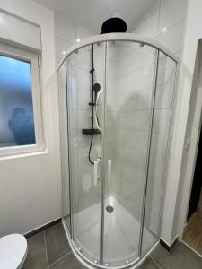 a glass shower in a bathroom with a toilet at Maison de ville a Berck in Berck-sur-Mer +7 photos