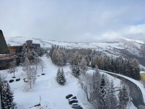 a snow covered mountain with cars parked in the snow at Ancolie in Villarembert