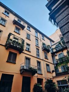 a large building with balconies and plants on it at Monti26 in Milan
