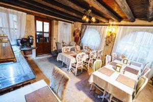 a dining room with tables and chairs and windows at Young Cave Hotel in Ortahisar
