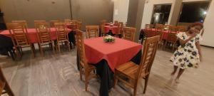 a young girl standing in front of a table in a restaurant at Orion Blue Hotel in Dombagahawatta