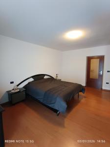 a bedroom with a bed in a white room at La casa del Gianni in Piano