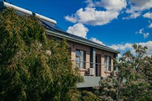 a building with a balcony on the side of it at Noble Hearts Bed & Breakfast in Maseru