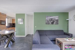 a living room with a couch and a table at 6 - Person Lake Area 28 Bungalow in Ewijk