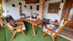 a wooden table and chairs in a yard at Tisza-tavi Menedék in Poroszló