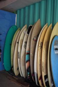 a bunch of surfboards lined up against a wall at EL TUMBO in El Gigante