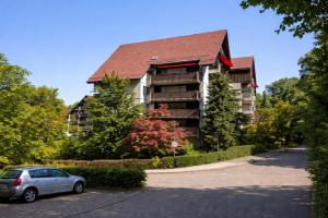 a building with a car parked in front of it at 21 Gramm Das Verborgene mit Tiefgarage in Sasbachwalden